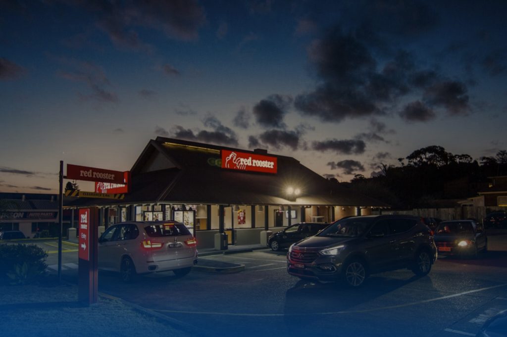 DRIVETHRU4 Restaurante Red Rooster em noite iluminada